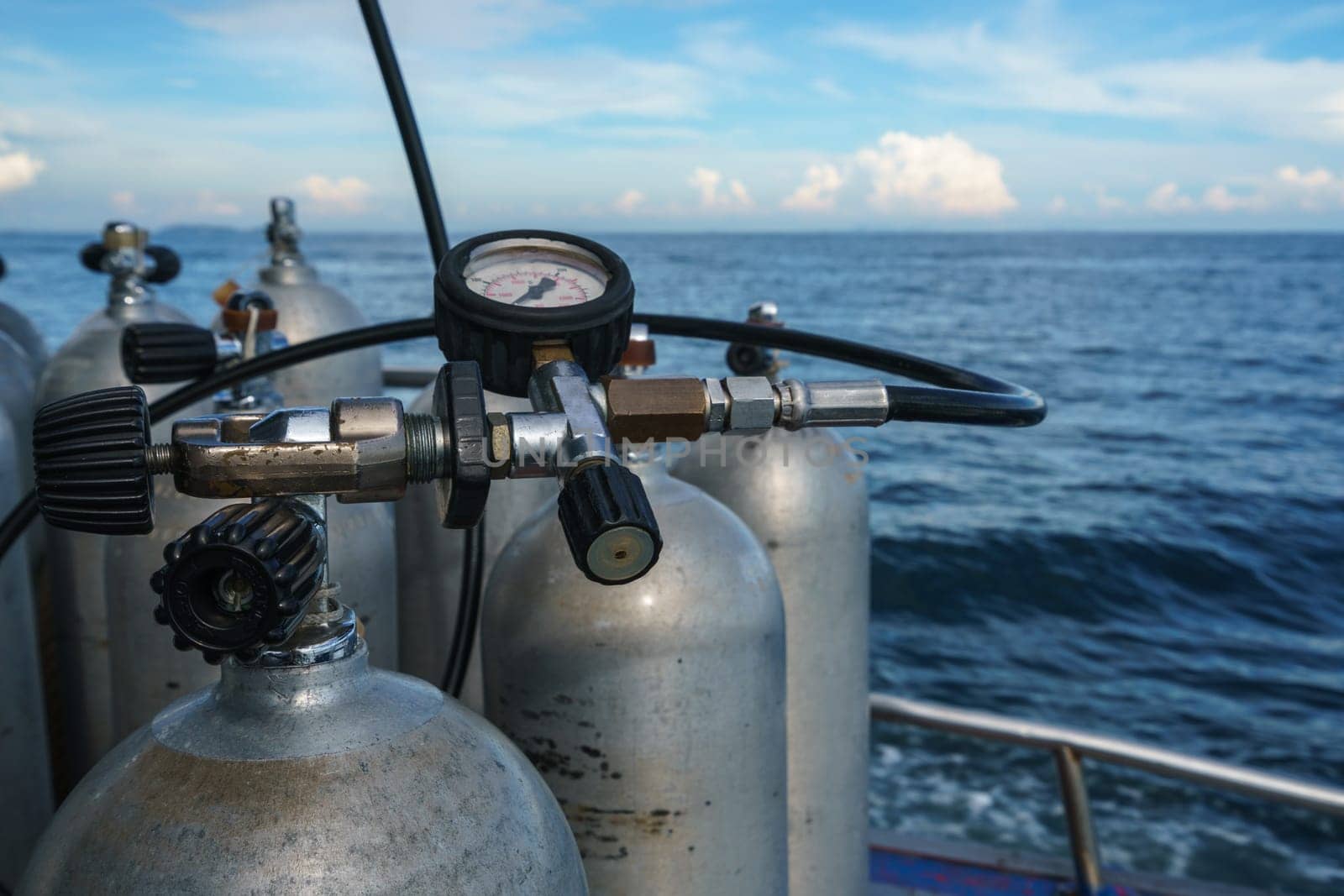 Diving equipment. Gas cylinders on sea backdrop, close-up