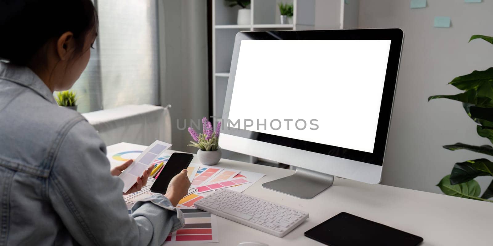 Woman sit at workplace desk with digital graphic staring at computer white mock up screen working professional program concept.
