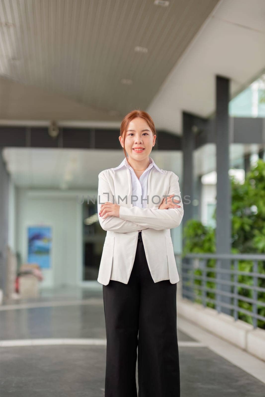 Successful business woman standing outside a office building.