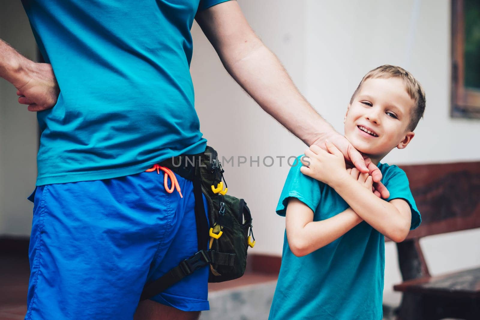 Closeup image of little son tender hugging his fathers hands. Happy childhood parenthood harmony by nandrey85