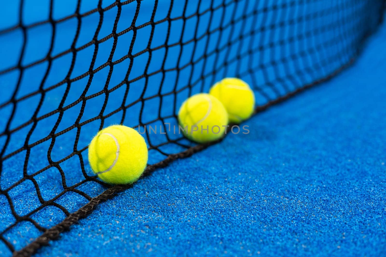 Three paddle tennis ball near the net, racket sports. High quality photo