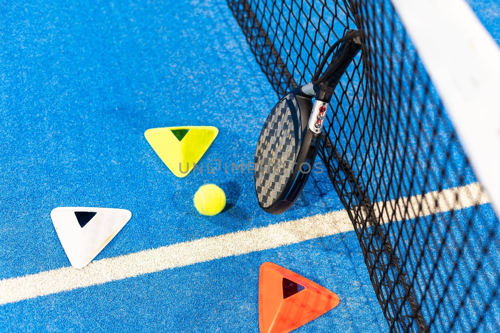 paddle tennis racket and balls on court, night image. High quality photo