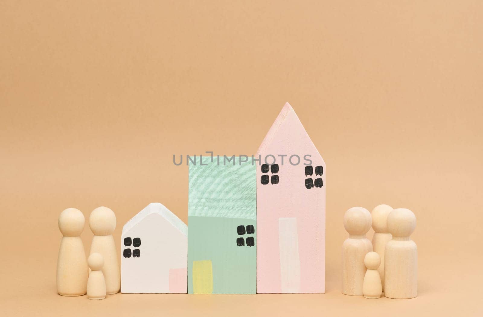 Wooden houses and wooden men of a family with children. Concept of searching for rental housing by ndanko