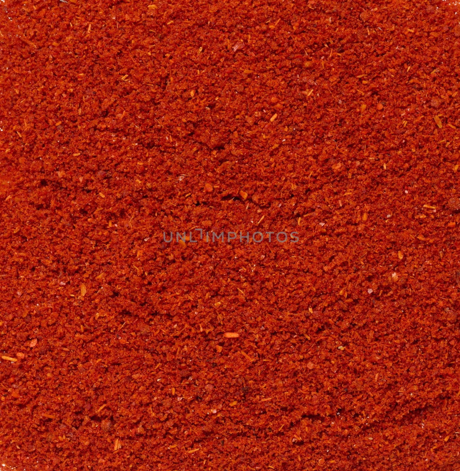 Texture of smoked ground red paprika, full frame