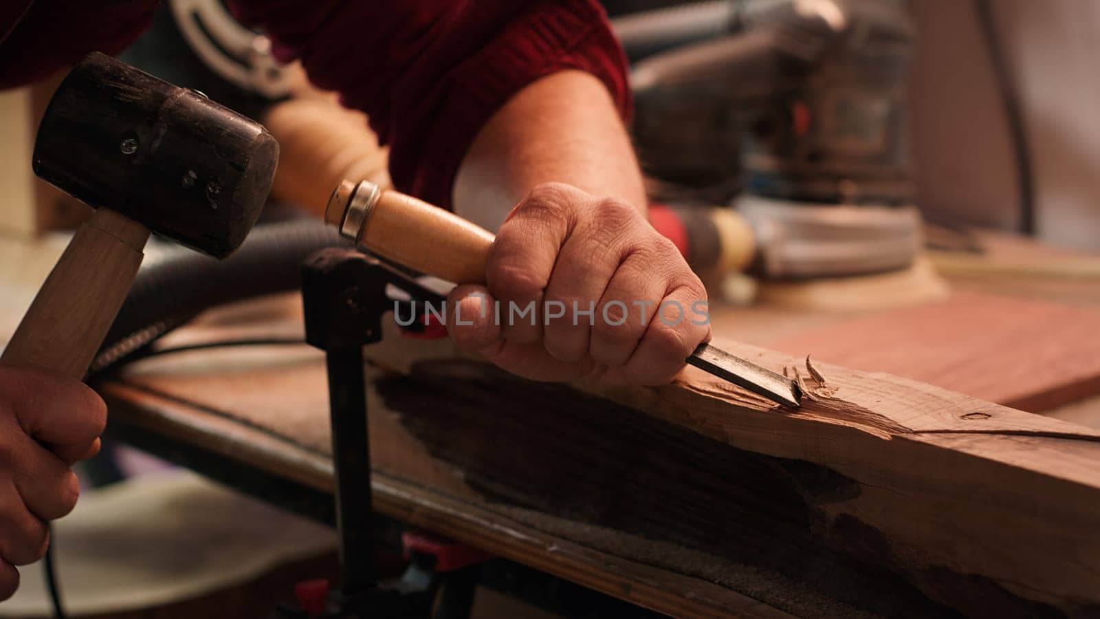 Manufacturer in studio shaping wooden pieces with tools, close up by DCStudio