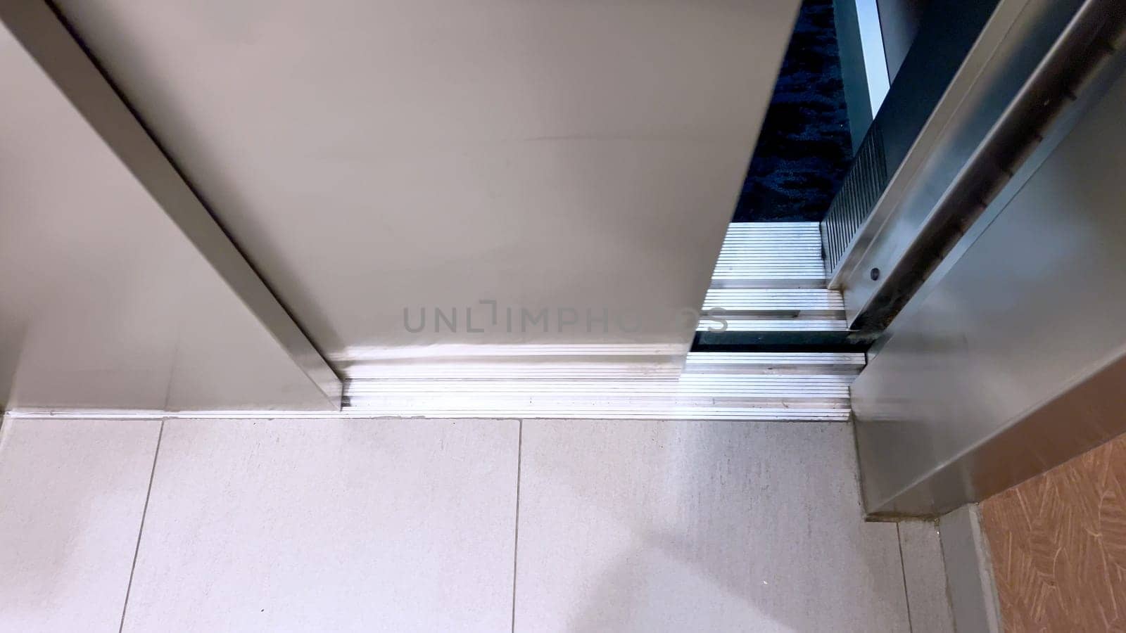The detailed view of an elevator threshold where the cabin meets the building floor, highlighting the transition space that facilitates safe entry and exit.