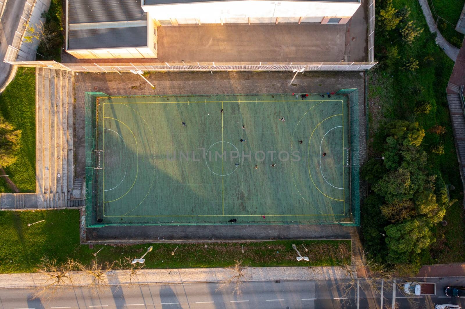 Aerial drone top view of mini football soccer field. Public sport ground in city at sunny summer day drone view