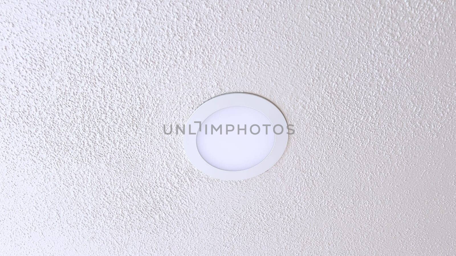 Minimalist Ceiling Light Fixture on Textured White Ceiling by arinahabich
