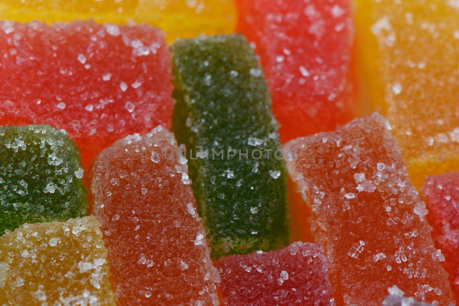 multi-colored marmalade pieces in sugar close-up. Studio photography, food photography