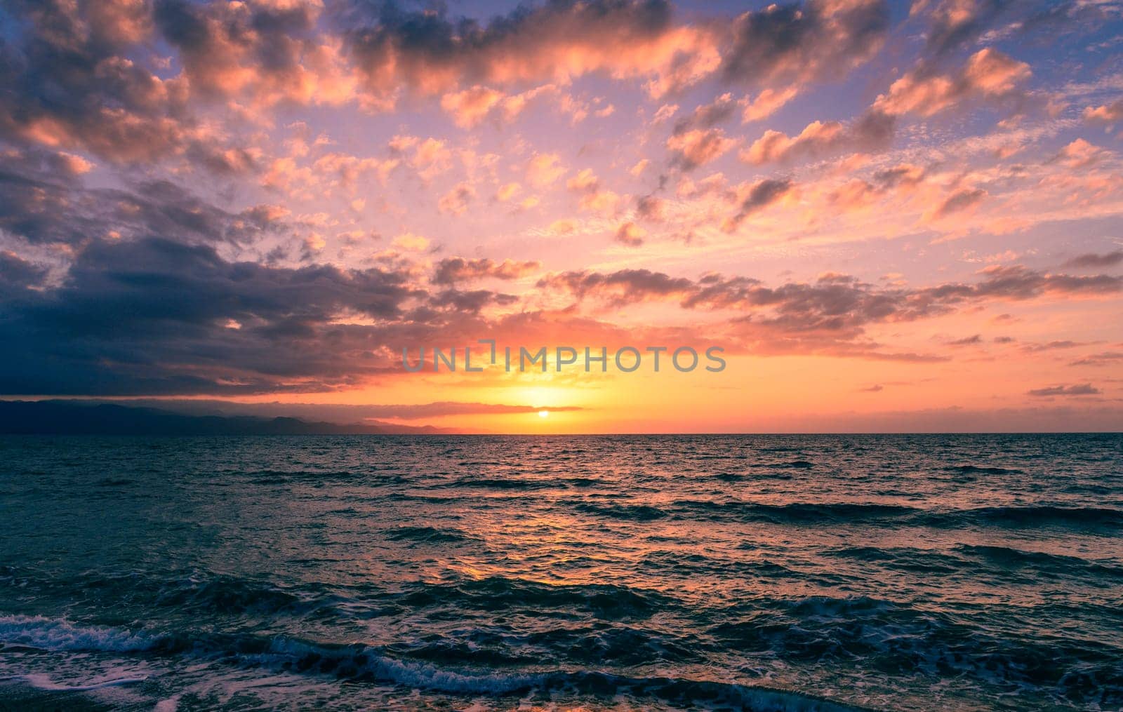 Stunning sunset beach scene with serene waves and captivating sky, perfect for meditation wallpaper.