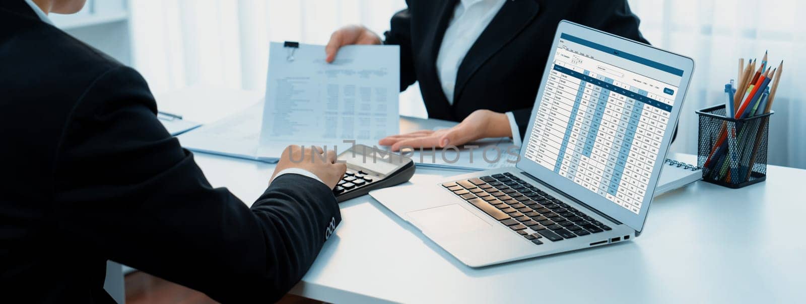 Corporate accountant team use accounting software on laptop to calculate and maximize tax refund and improve financial performance base on financial data. Modern business accounting . Shrewd