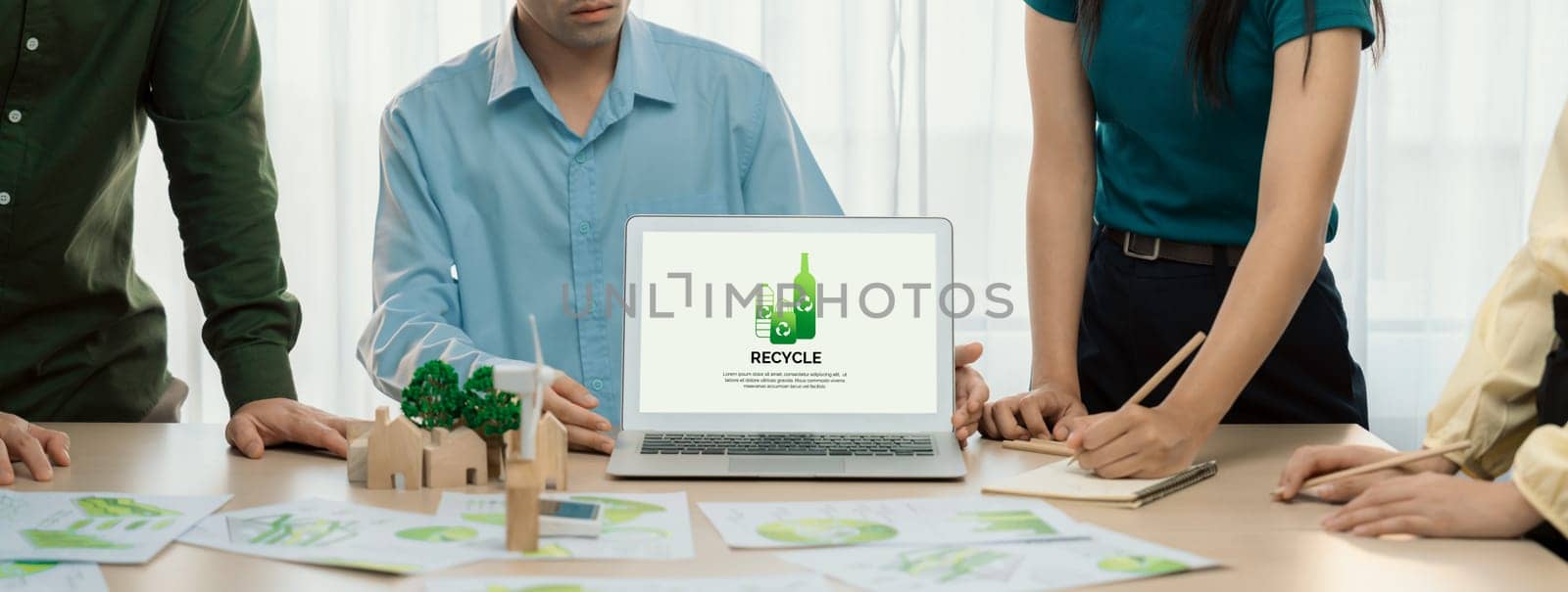 Recycle packaging displayed on laptop at a green business meeting while business team presenting green design. ESG environment social governance and Eco conservative concept. Closeup. Delineation.