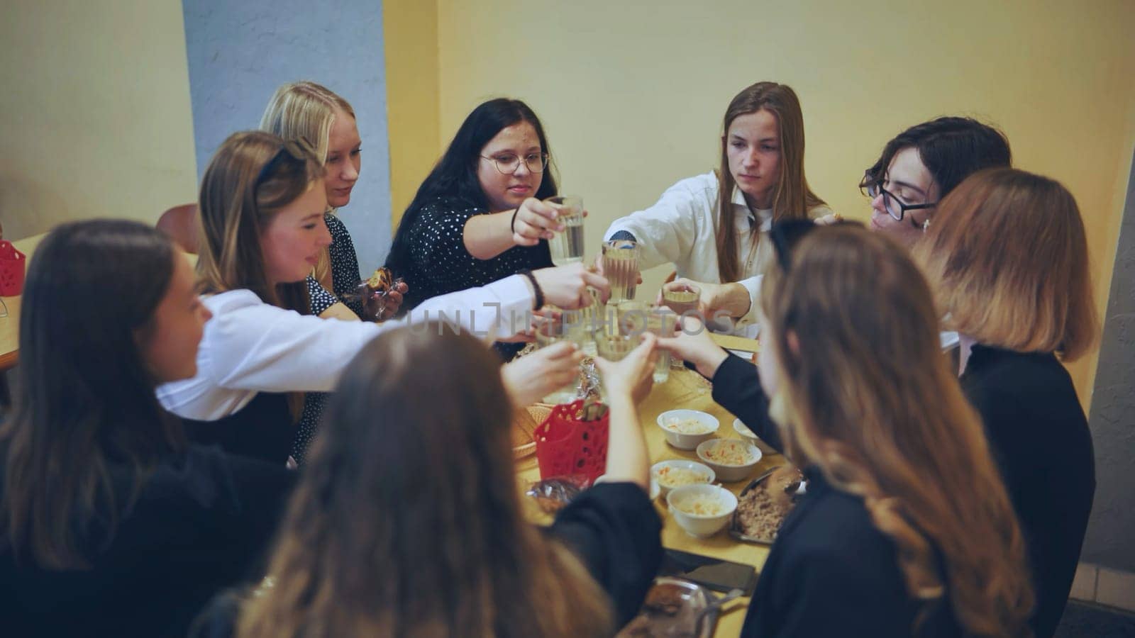 High school children eat in the school canteen. by DovidPro