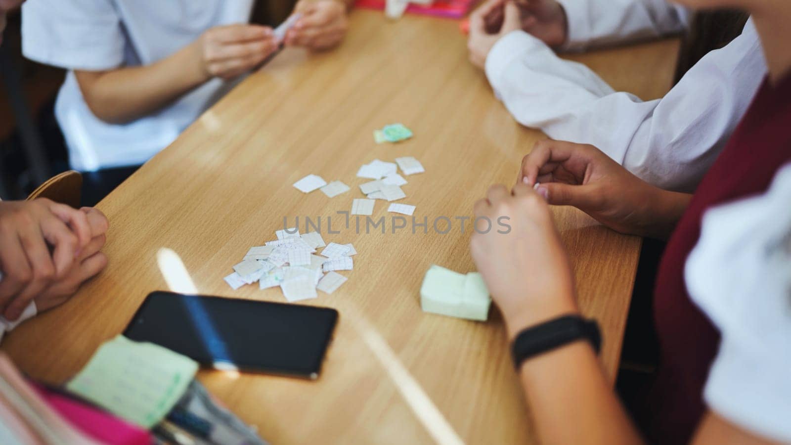 Children play with homemade small papers. by DovidPro