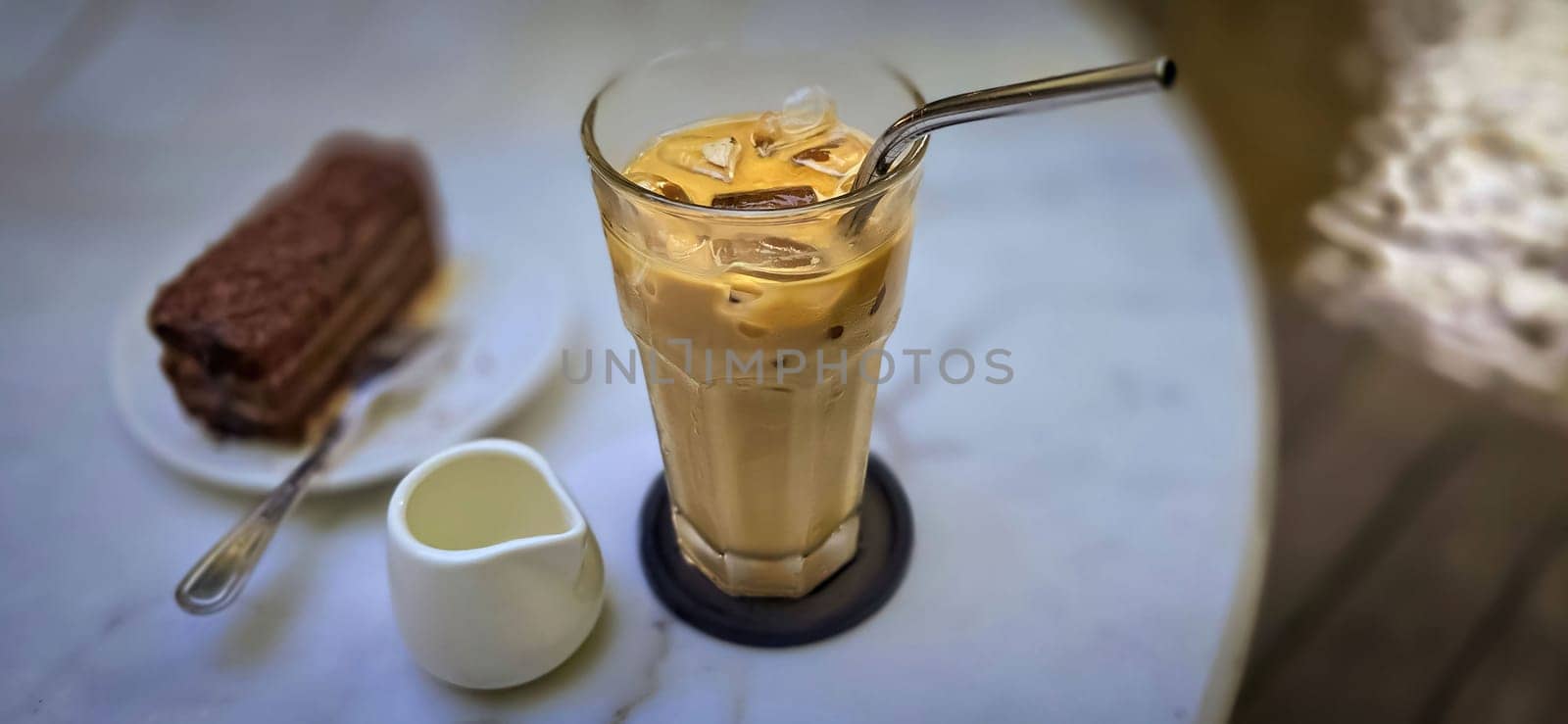 Fresh iced coffee in glass with frothy cream for your design, Food concept in style, copy space by antoksena