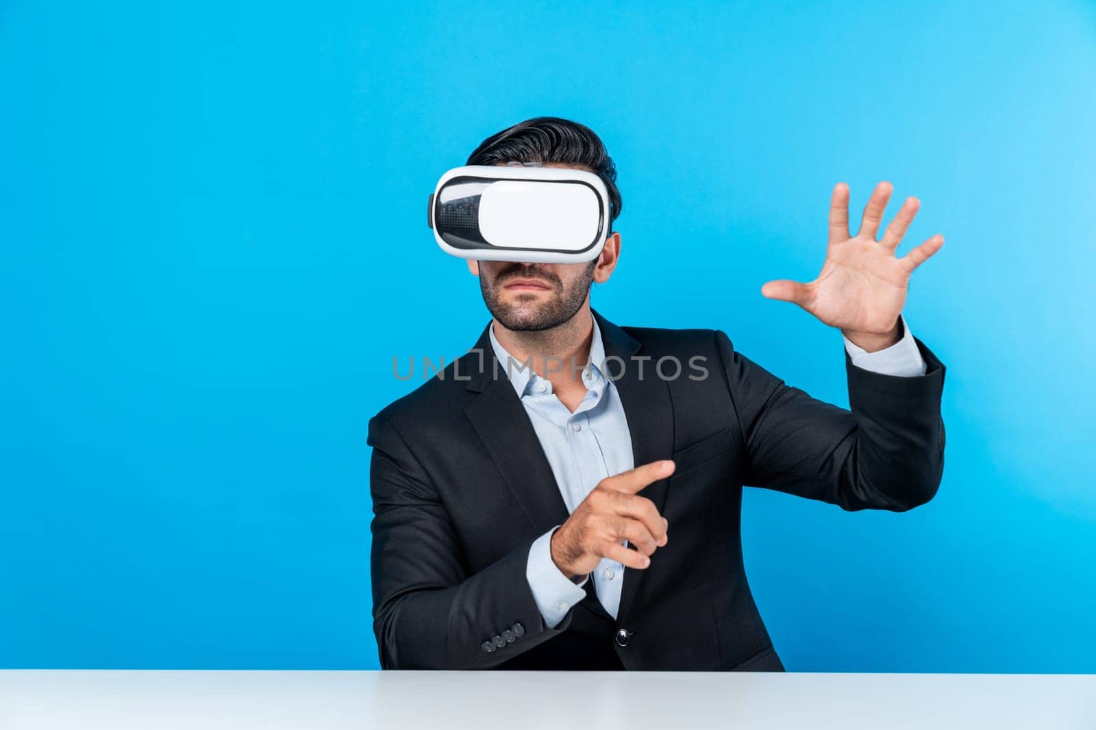 Smart businessman sitting while pointing and choosing data analysis by using technology innovation. Professional caucasian project manager using virtual reality glasses and VR goggles. Deviation.