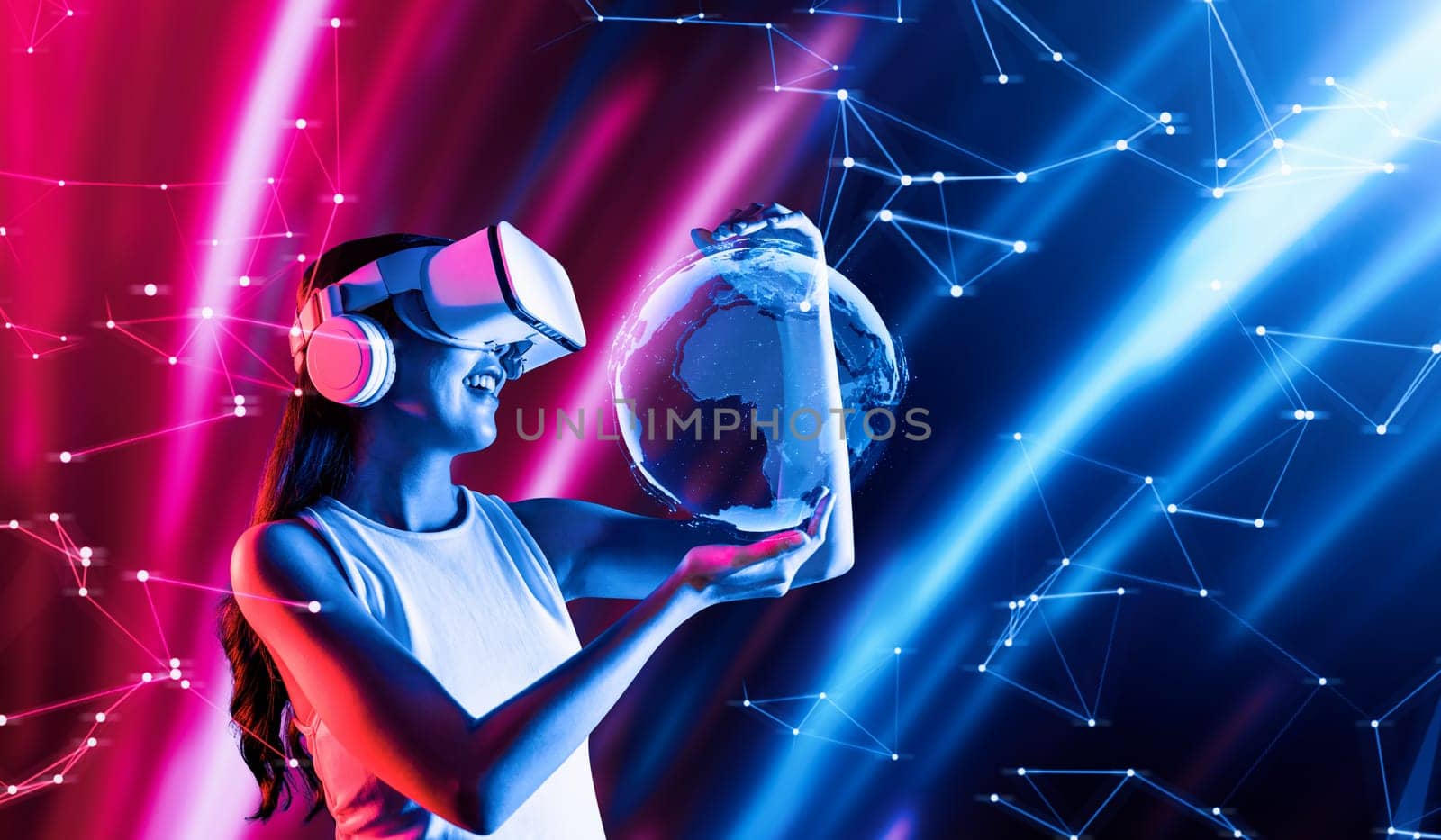 Female stand in cyberpunk neon light wear white VR headset and tank top connecting metaverse, future cyberspace community technology. Woman holding and watch 3D global picture hologram. Hallucination.