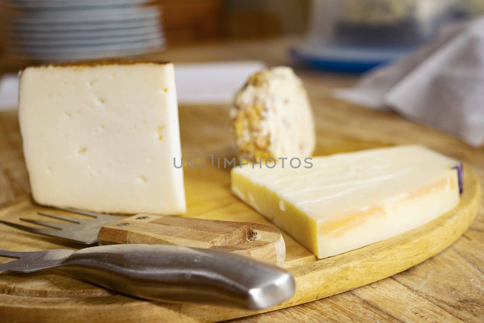 chopping board of various cheeses by salmas