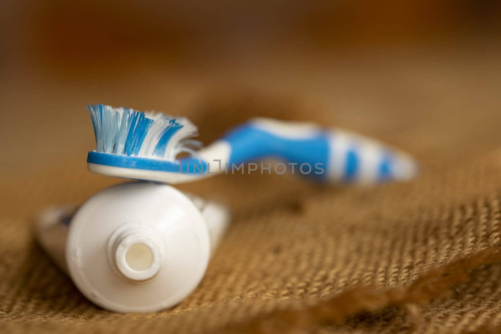 cleaning teeth with toothbrush and toothpaste by salmas