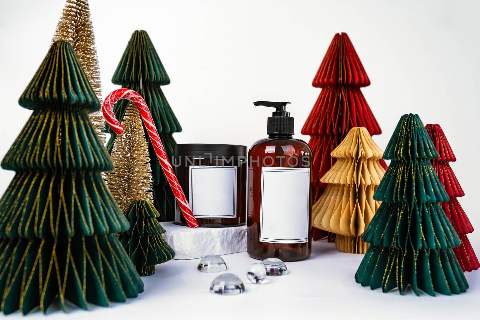 dark jar with lid and dispenser on the background of Christmas decorations, side view by tewolf