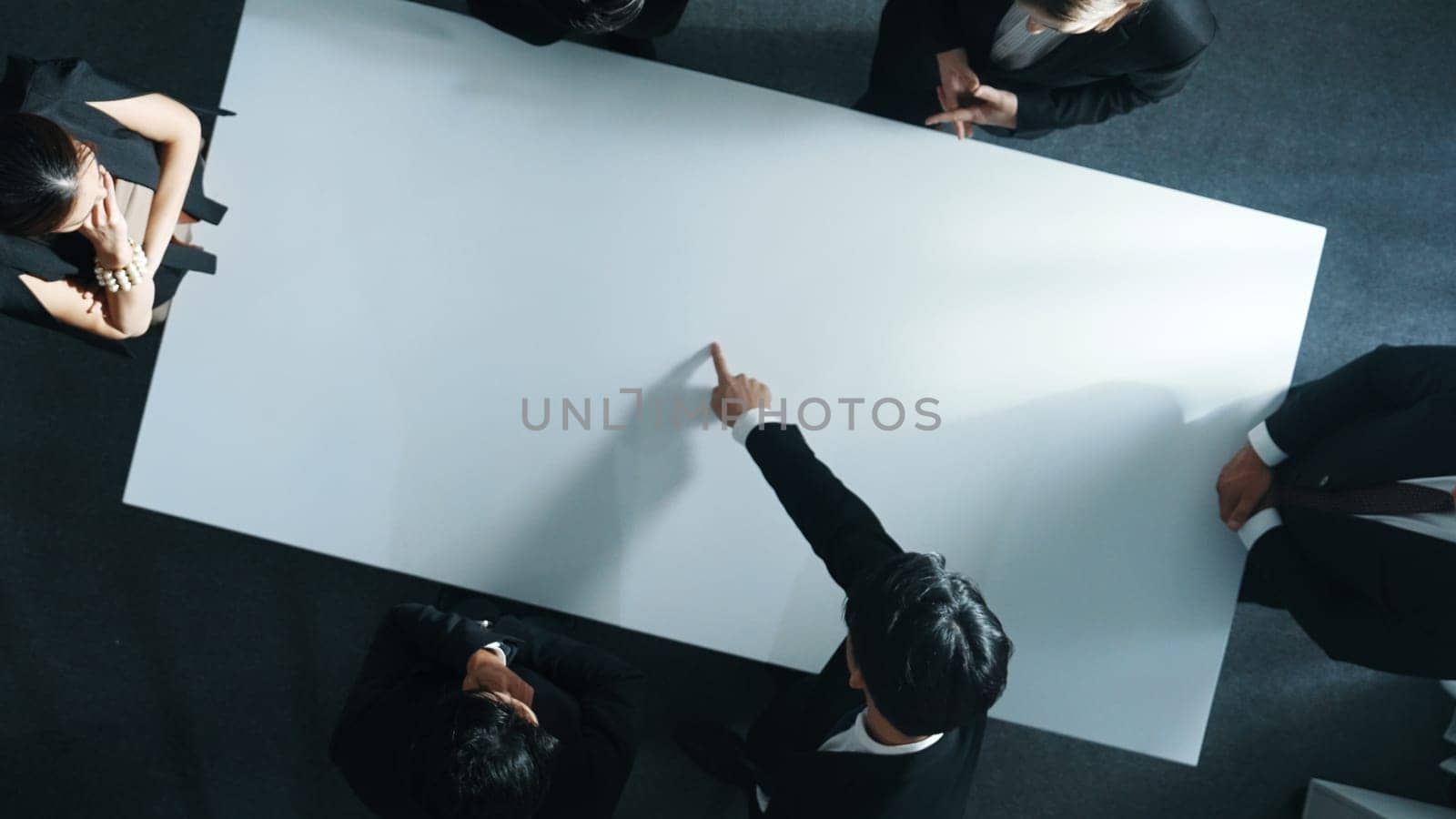 Top down aerial view of smart cooperate businessman discussing about marketing strategy. Diverse business group brainstorming idea startup project and financial plan at meeting room. Directorate.