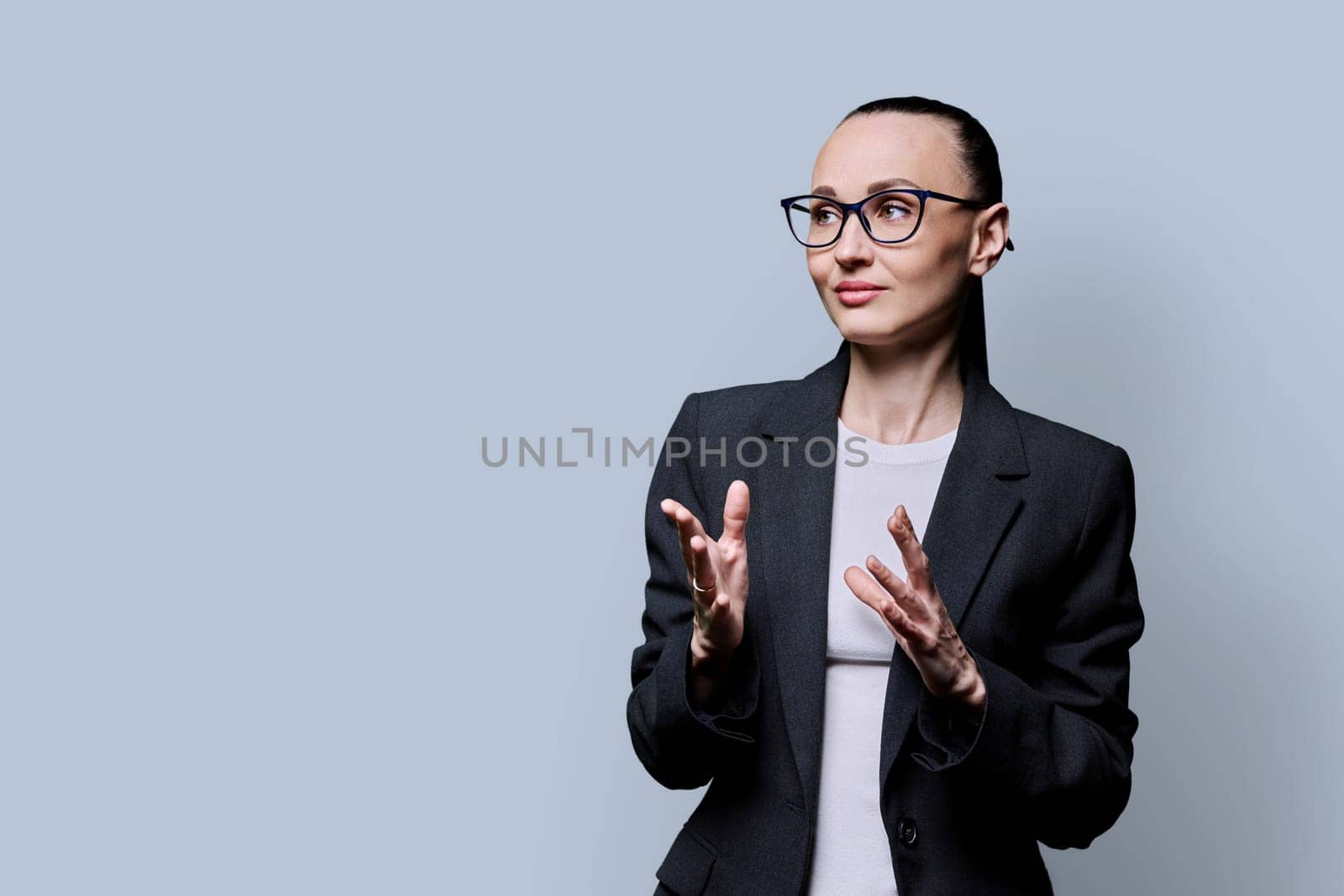 Portrait of thinking serious confident business woman , on grey studio background by VH-studio