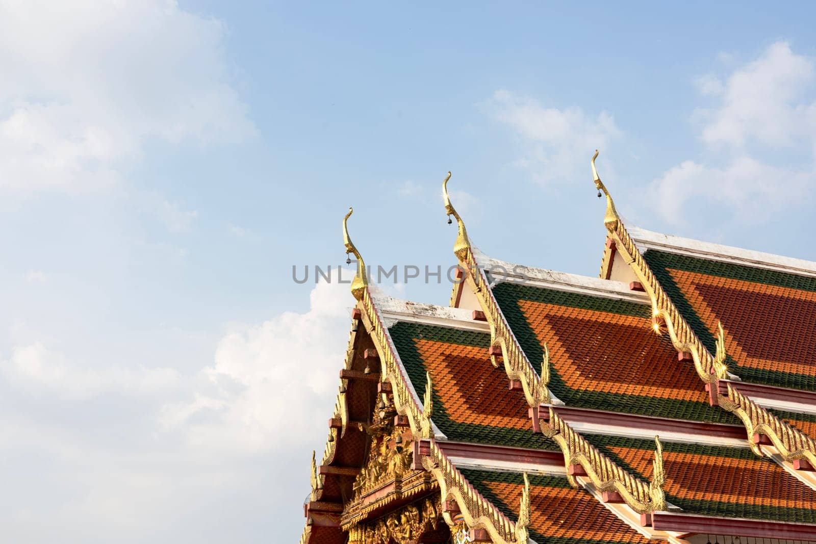View of the blue sky and the roof church at Buddhist temple in Thailand. Roof Of Thai Temple With Blue Sky And Cloud.