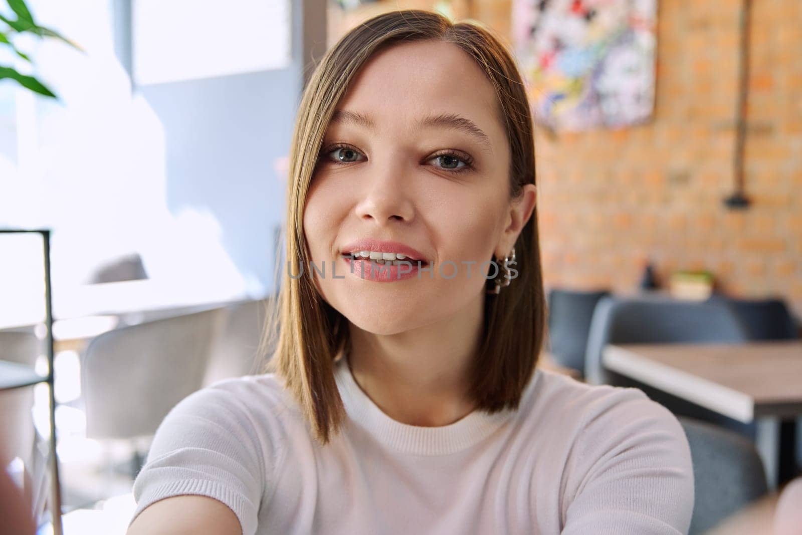 Close up selfie portrait of young beautiful woman by VH-studio