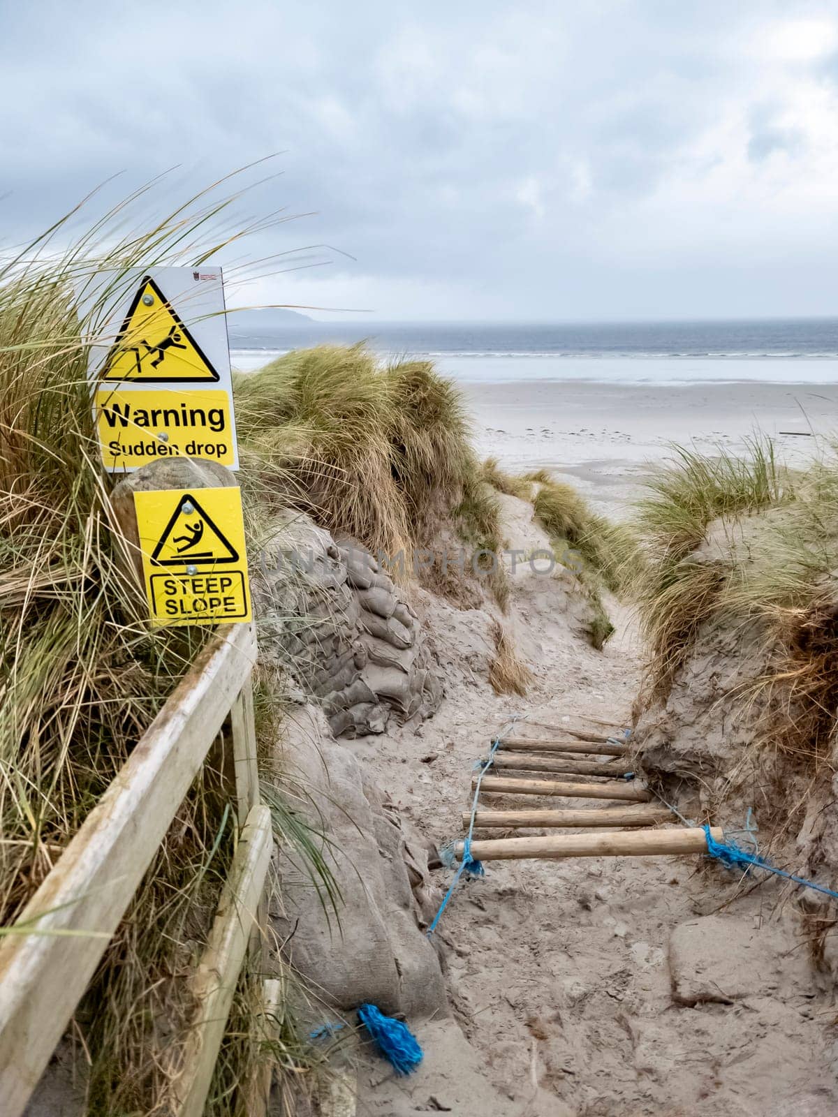 Signs warning of Sudden Drop and Steep Slope at Dooey beach by Lettermacaward in County Donegal - Ireland