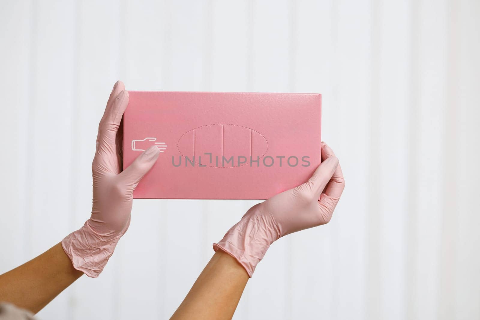 Box of new medical gloves isolated on white. Hands of a woman holding a box with gloves. The concept of cleanliness and sterility in work. by uflypro