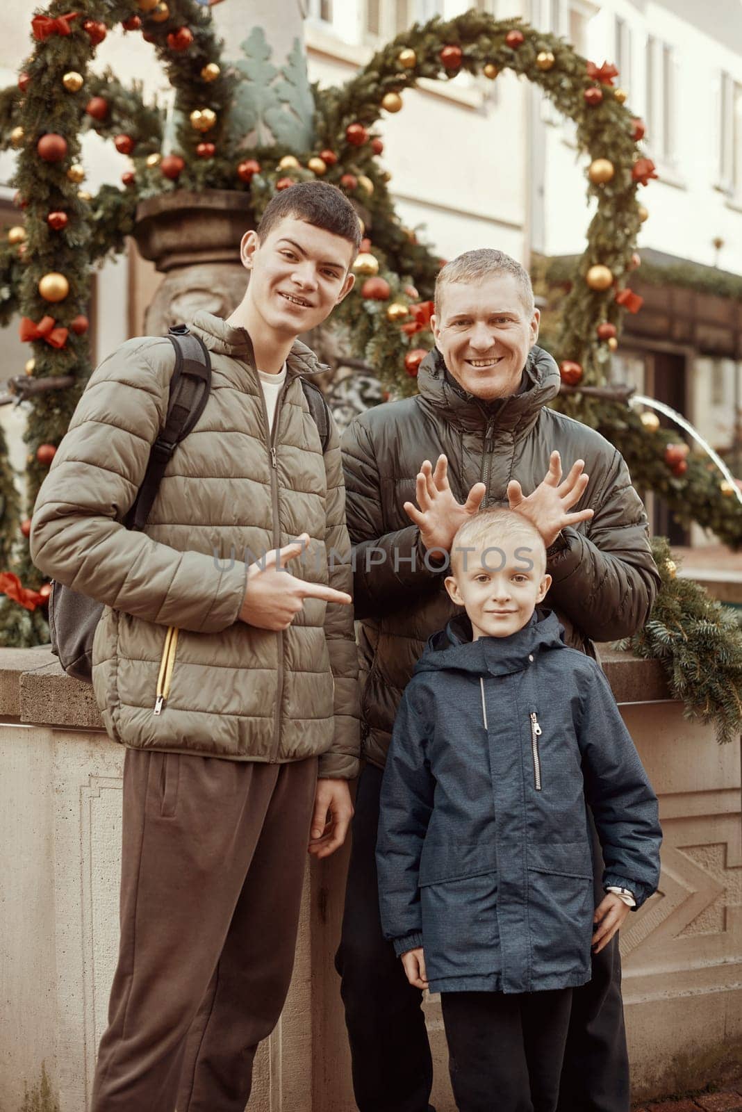 Joyful Family Portrait: Father and Two Sons by Festive Vintage Fountain. by Andrii_Ko