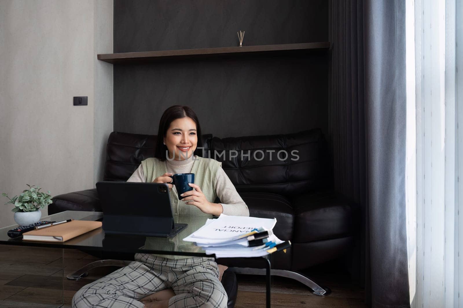 Asian business woman relax and working on laptop remotely from home. work from home concept.