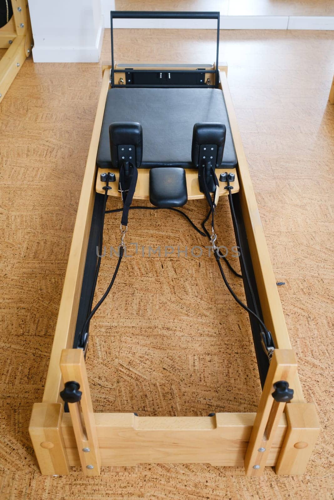 the reformer machine in the pilates room. Yoga equipment by Lobachad