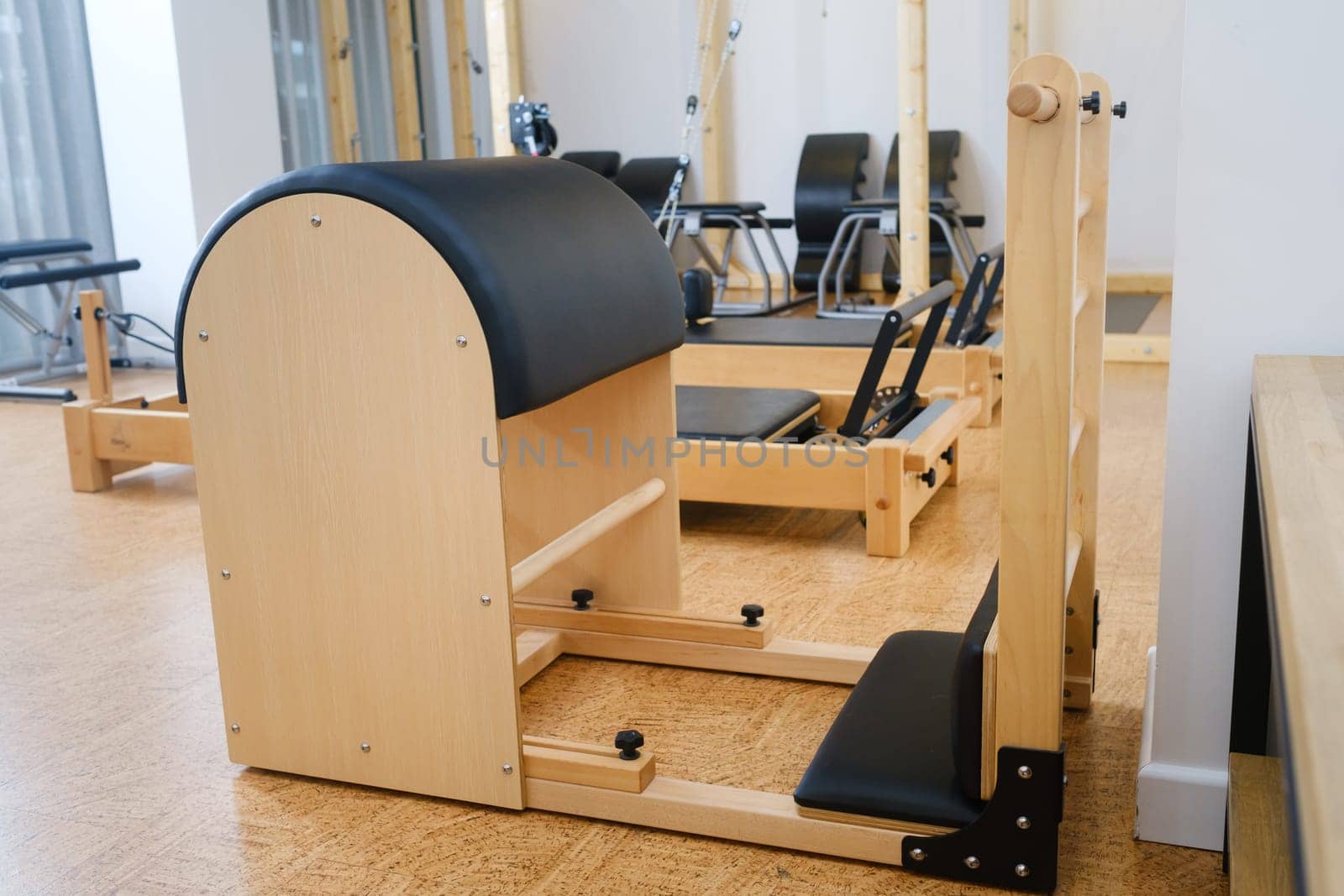 Pilates simulator is a barrel in the yoga room. Pilates equipment.
