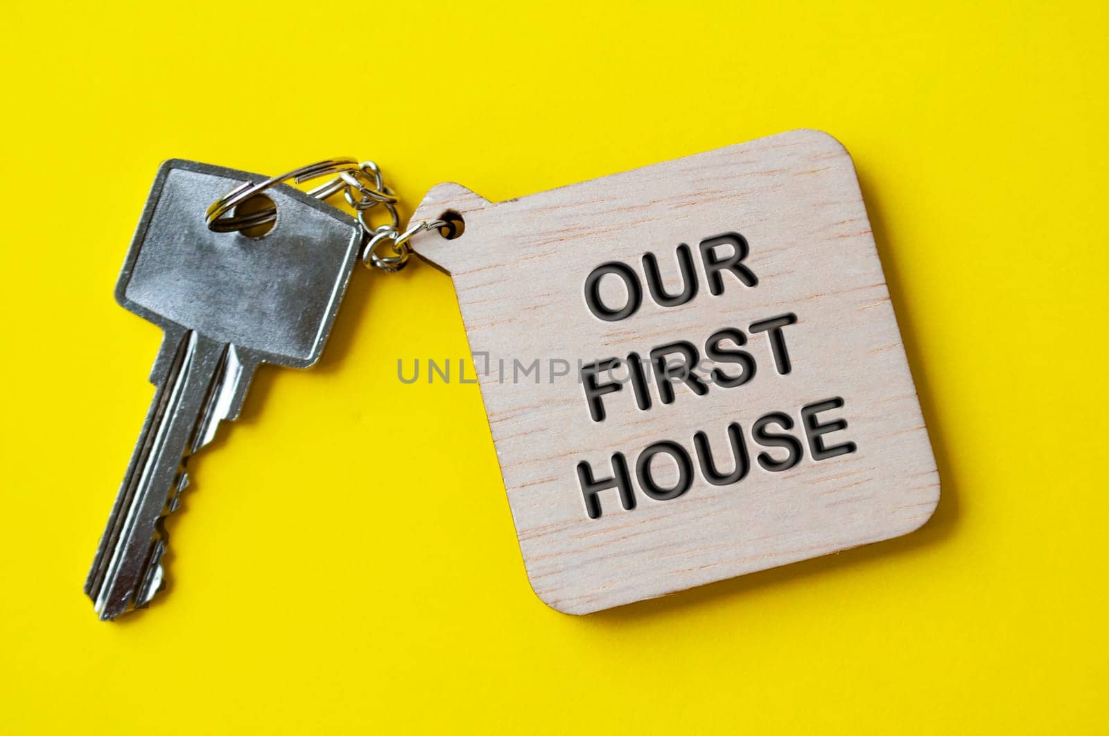 Our first house text engraved on wooden key chain.