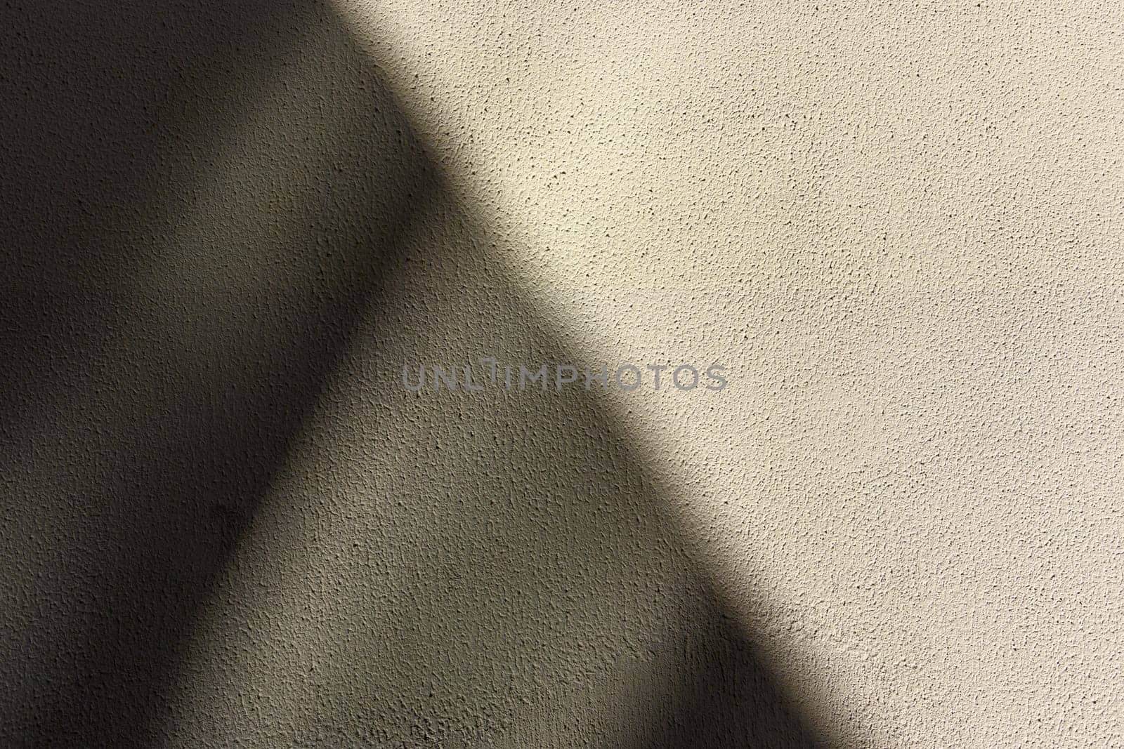 , diagonally divided gray wall casting a shadow as a background 5