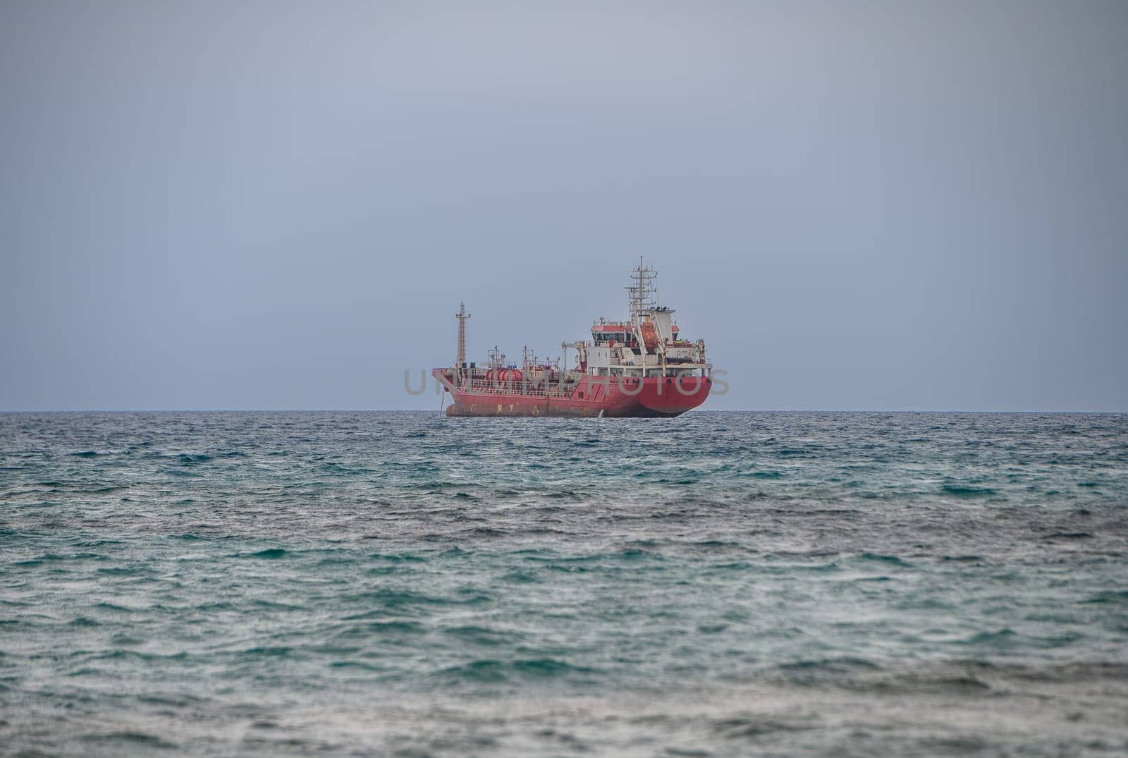 Fishing ships are in the roadstead at sunset