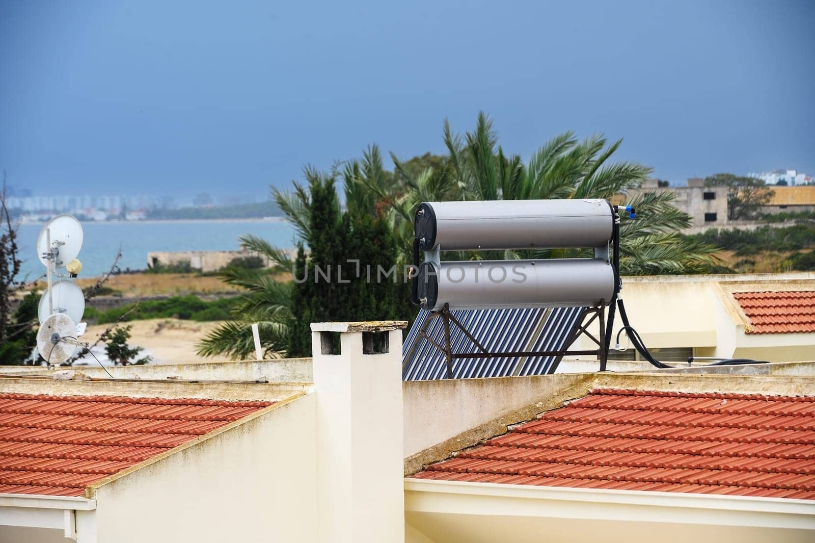 Solar boilers for water heating on the roofs of houses. Solar heated water.