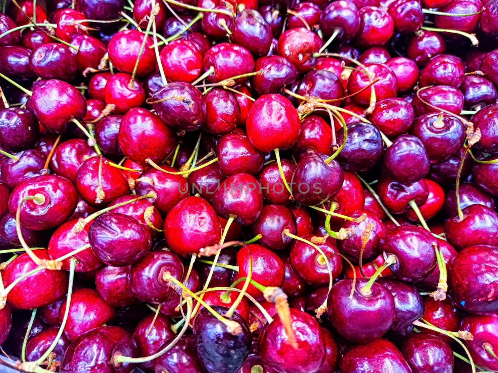 Fresh Cherries on Display at a Local Market. A vibrant array of ripe cherries up close by keleny