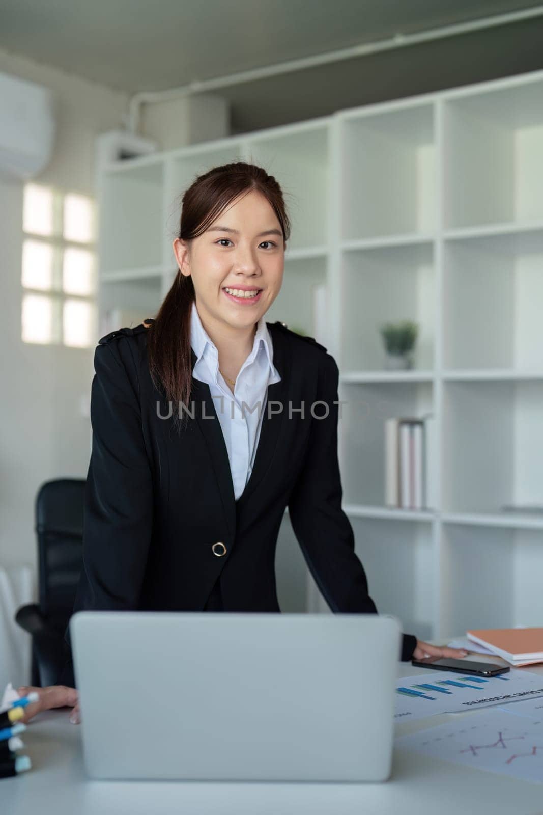 Young successful employee or business woman at desk at office. Achievement career concept by nateemee