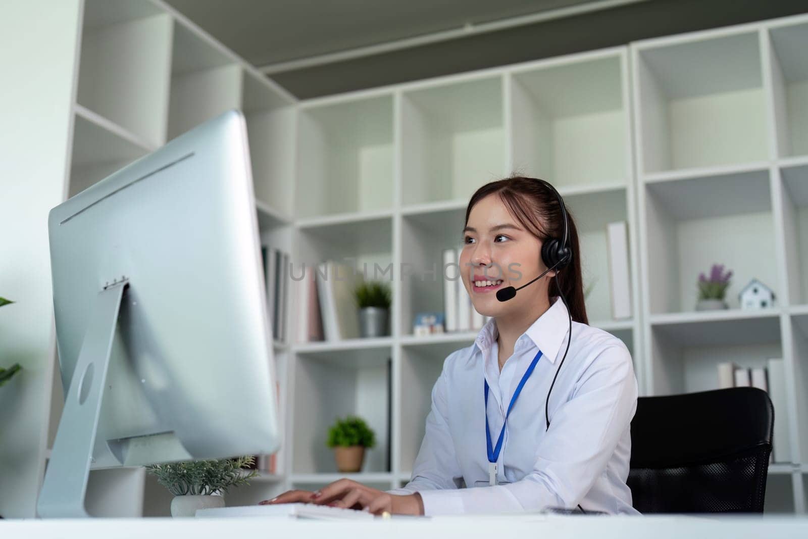 Call center woman asian in office for customer service, technical support and advice, contact and communication with employee operator in help desk agency by nateemee