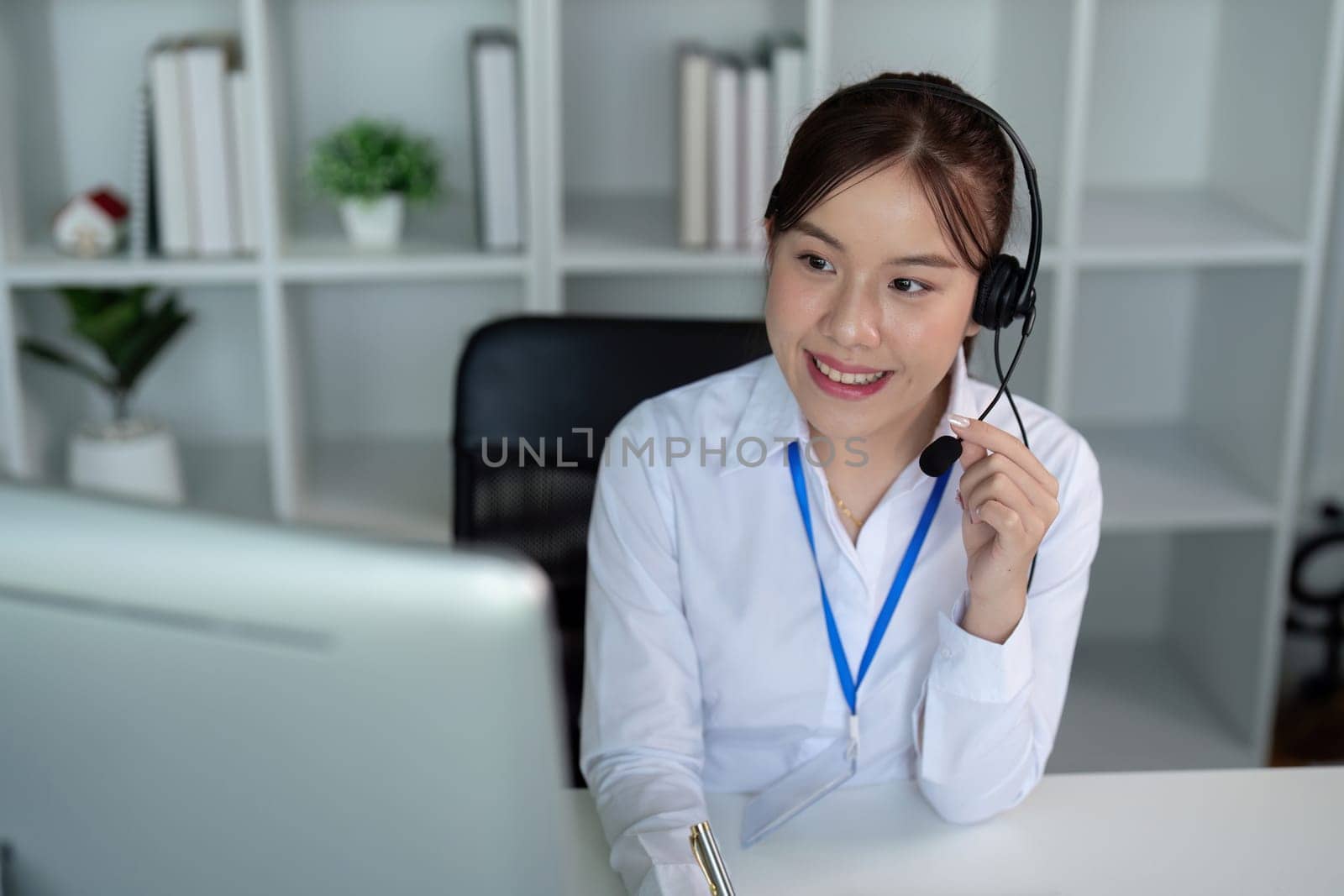Call center woman asian in office for customer service, technical support and advice, contact and communication with employee operator in help desk agency by nateemee