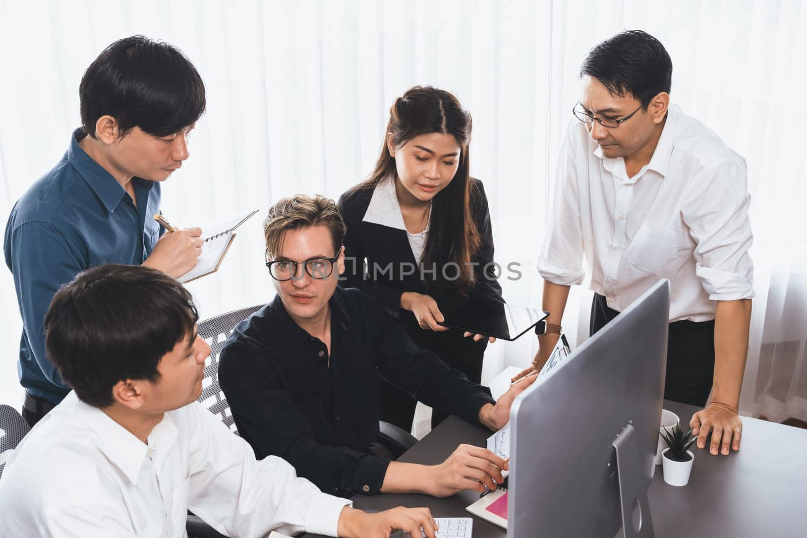 Group of diverse office worker employee working together on strategic business marketing planning in corporate office room. Positive teamwork in business workplace concept. Prudent