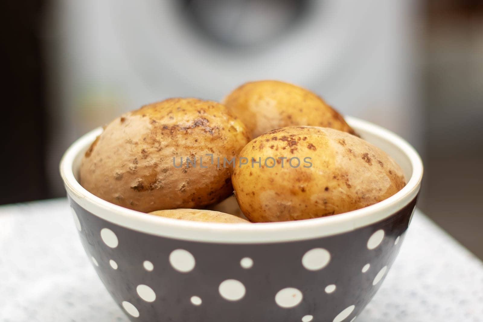 Potatoes, a staple food, are being cooked in a pan with water. These root vegetables are a natural food ingredient used in various cuisines