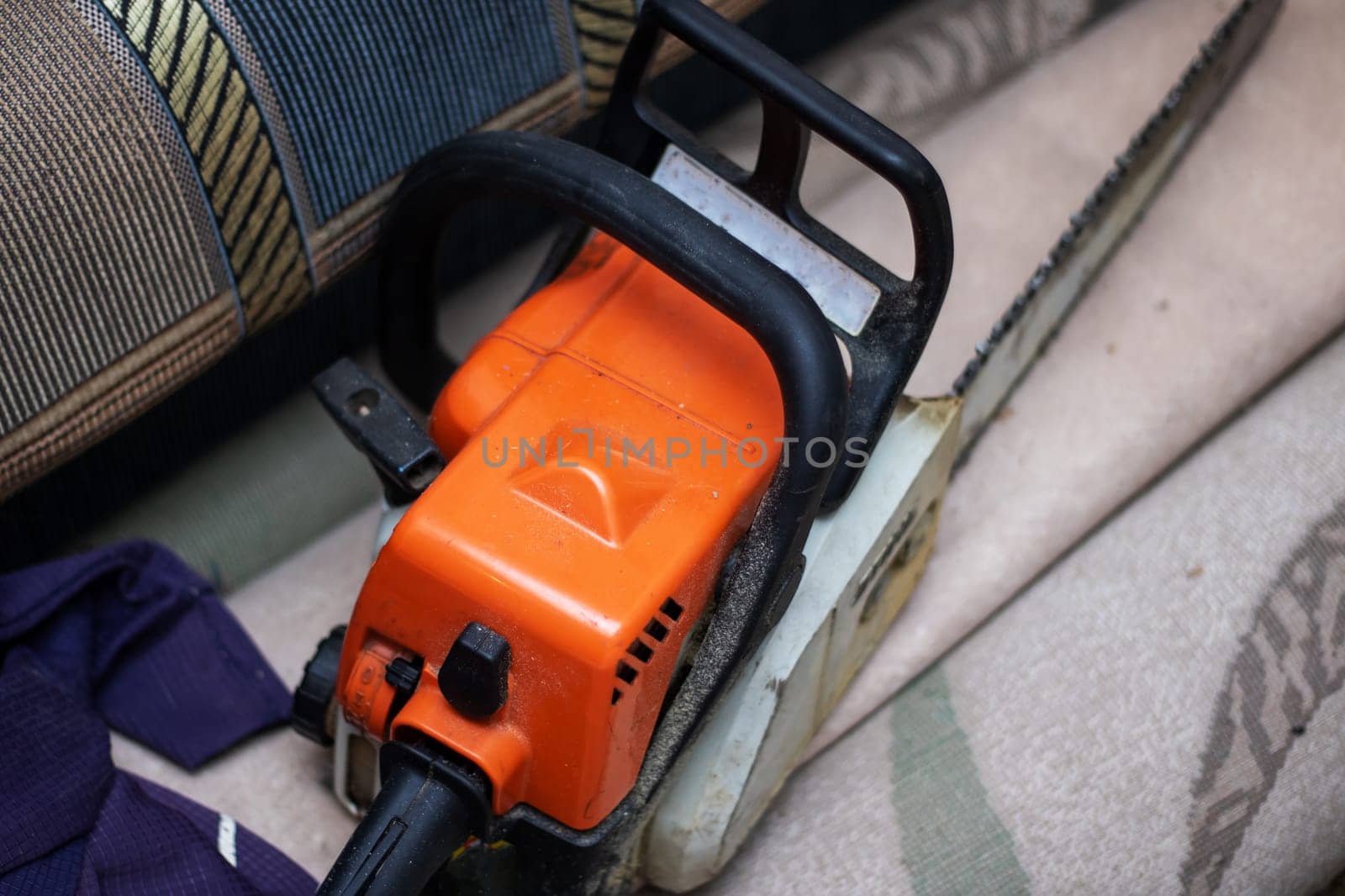 Chainsaw rests on hardwood flooring, a powerful gas machine by Vera1703