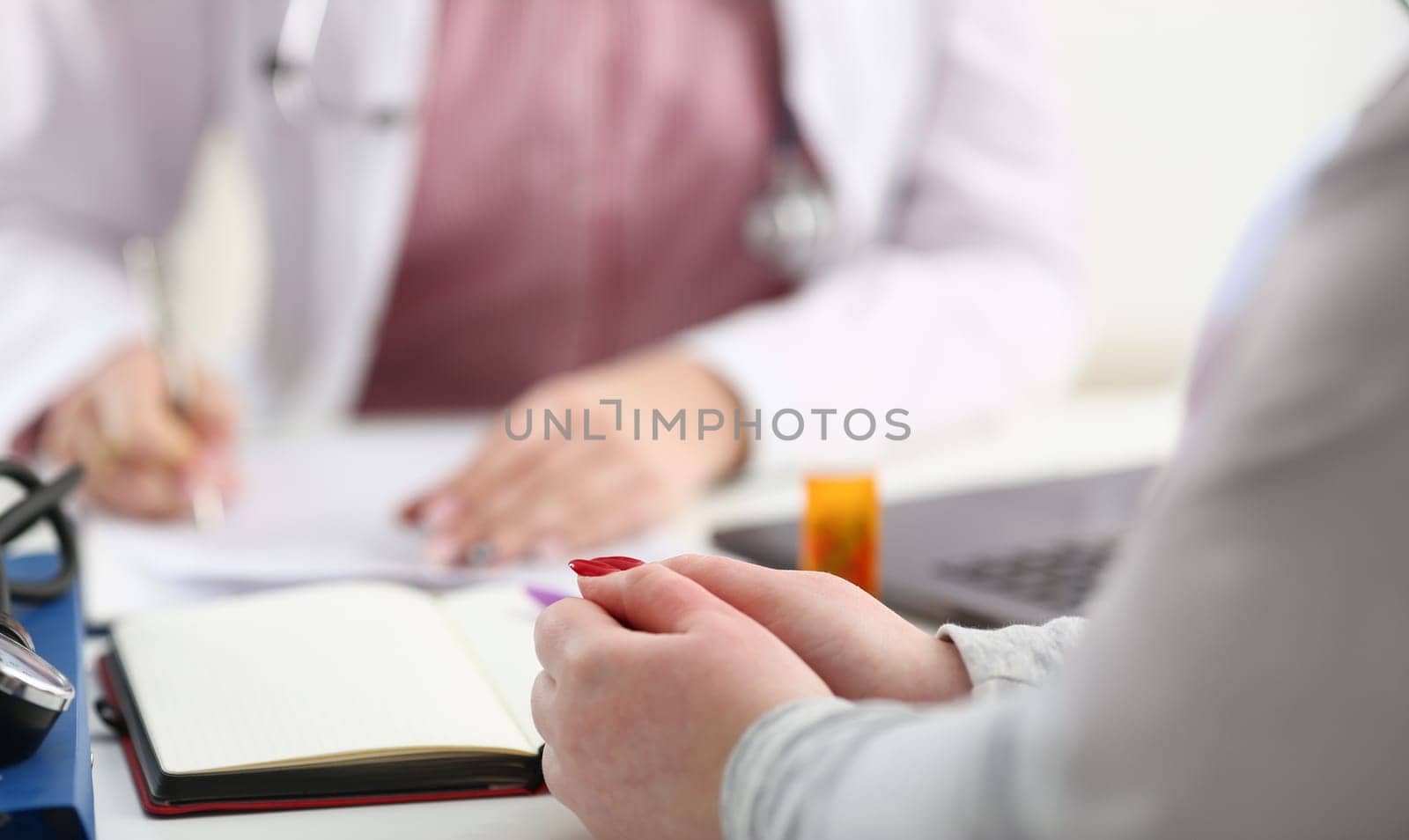 Female doctor hand hold silver pen filling patient history list at clipboard pad. Physical exam er disease prevention ward round visit check 911 prescribe remedy healthy lifestyle concept