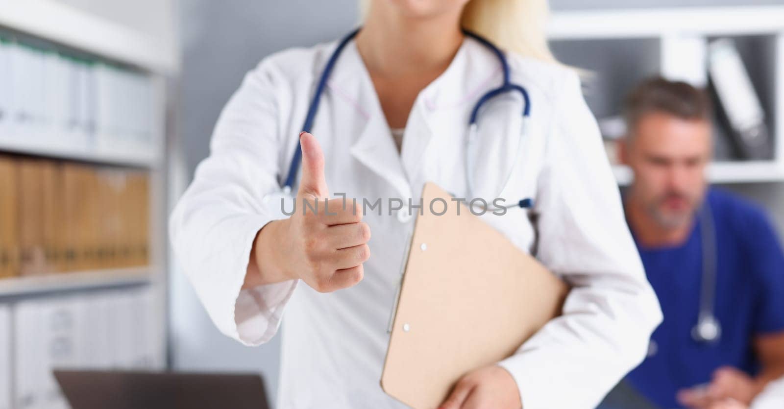 Arm female doctor hand showing ok or confirm sign with thumb up closeup. High level therapeutist consultation best treatment healthy lifestyle satisfied patient physical exam concept