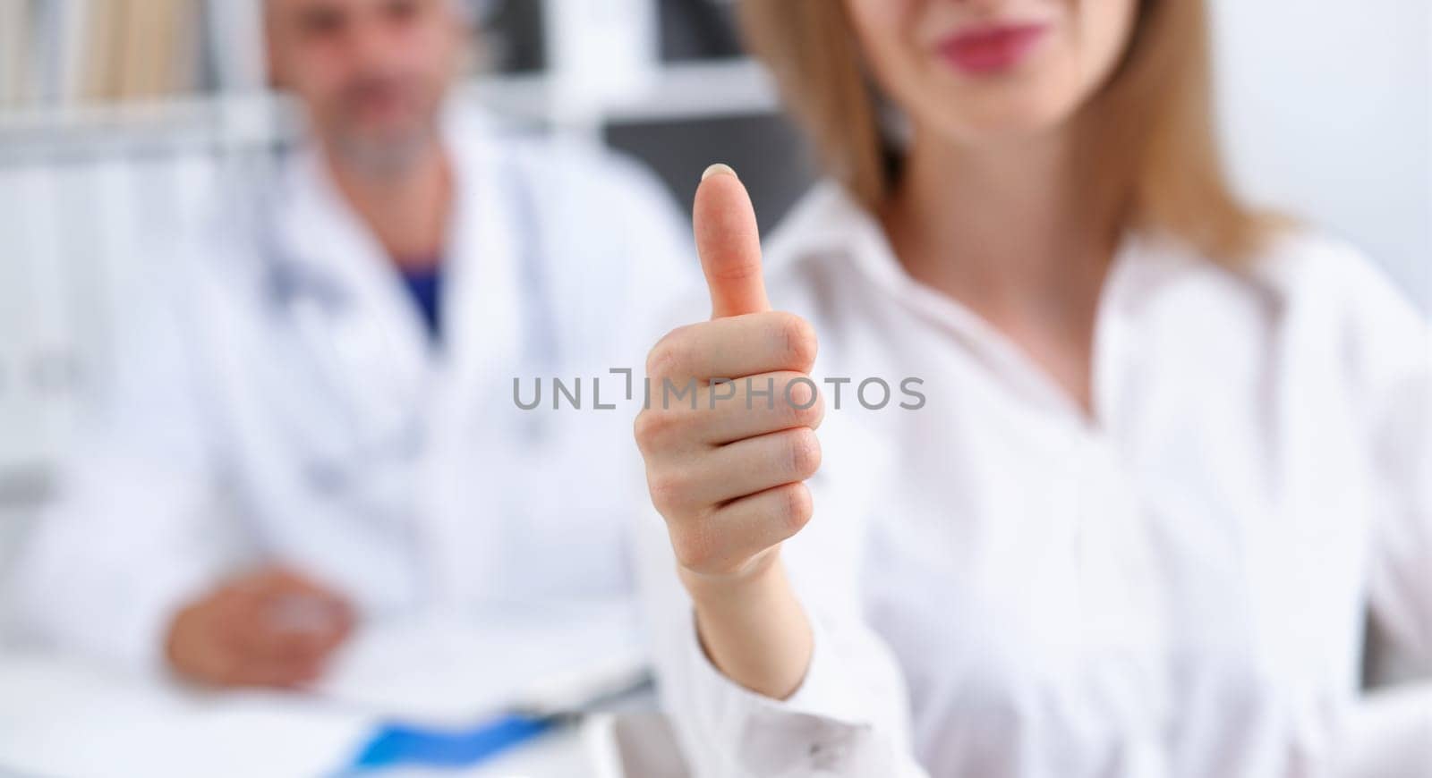 Arm show ok or confirm with thumb up at doctor office closeup. High level work confident satisfied client do like visit best occupation healthy life emergency help teamwork success concept