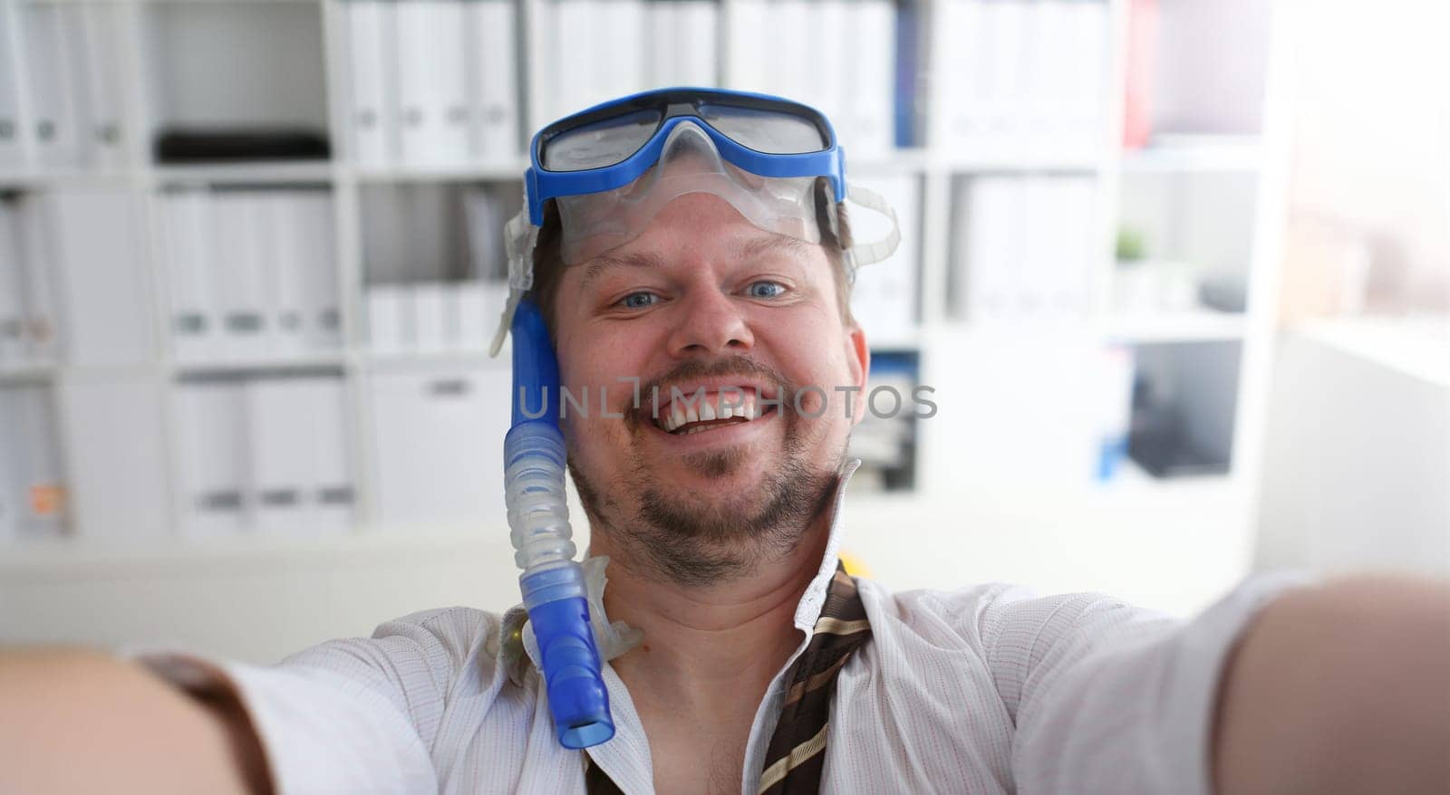 Man wearing suit and tie in goggles and snorkel by kuprevich