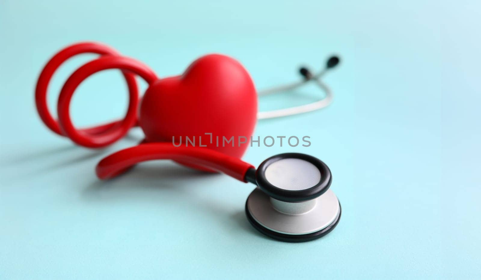 Red stethoscope with heart on blue modern background by kuprevich